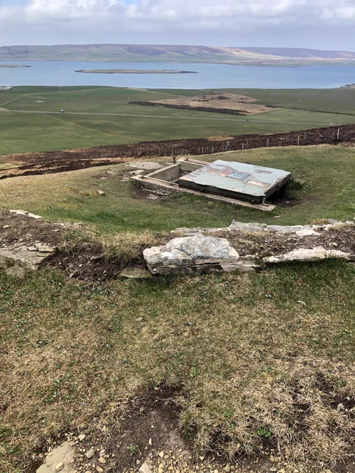 Sliding entrance to Wideford Hill cairn, sea in distance