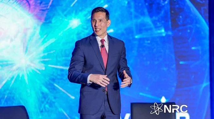 Image is a photo of a person standing on stage.