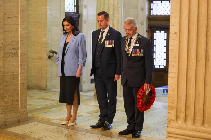 Image of three people - including deputy First Minister Emma Little-Pengelly - standing in the Great Hall at Parliament Buildings in Belfast