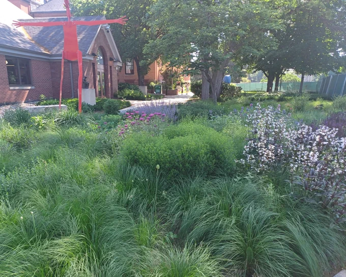 The ISU Anderson Sculpture Garden with flowers in bloom.