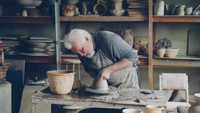 Silver-haired potters throws next work.  Photo by Vitaly Gariev on Unsplash