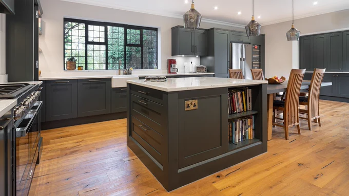 Kitchen island with bookshelf and dropped dining table.
