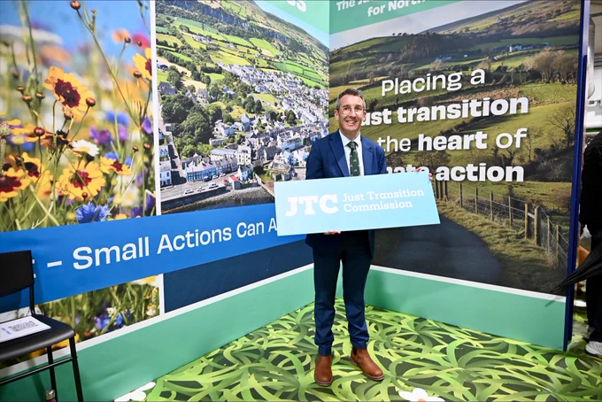 Minister holding just transition sign.