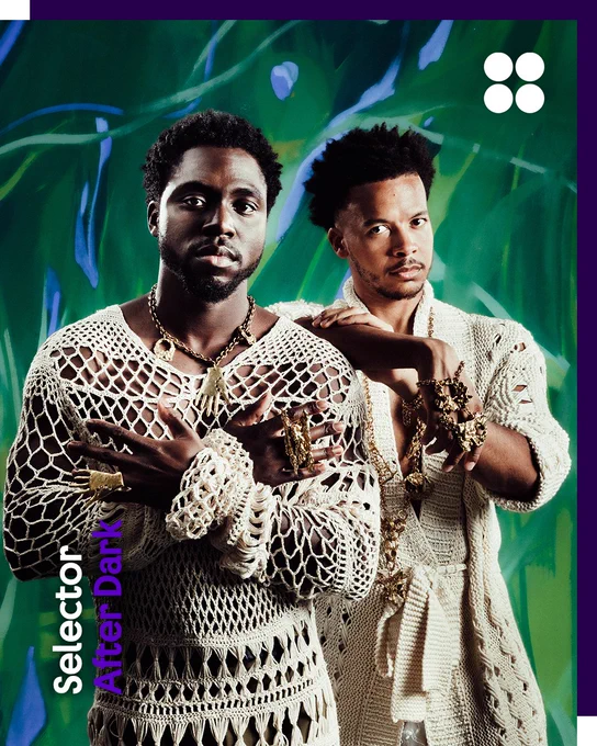 A duo, Blue Lab Beats are wearing cream-coloured crocheted garments and gold jewellery pose against a vivid green abstract background. The Selector Radio logo appears vertically in the bottom left corner alongside the name “After Dark” in purple text, while the British Council logo (four white circles) is in the top right. The border is dark purple.