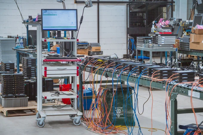 A perspective shot of the OceanTech warehouse floor showing specialized workstations where servers are prepared for proprietary software deployment.