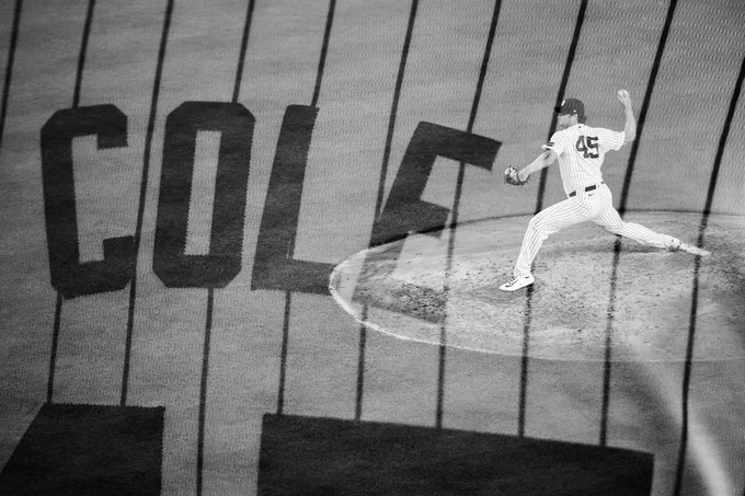 Double exposure: 
Gerrit Cole pitches
Fan's pinstripe Cole jersey. 
