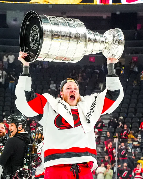 Photo of Eric Robinson hoisting the Cups 