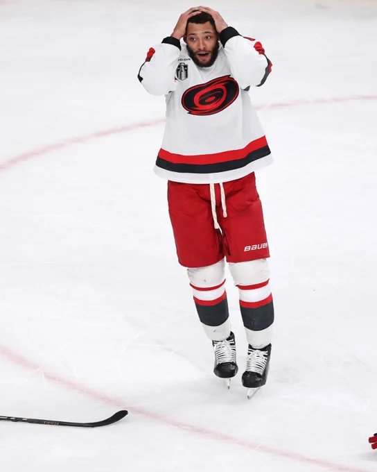 Photo of K'Andre Miller on ice in a Hurricanes uniform.