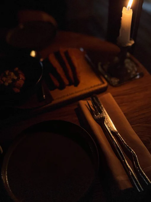 Dark candlelit dinner setting