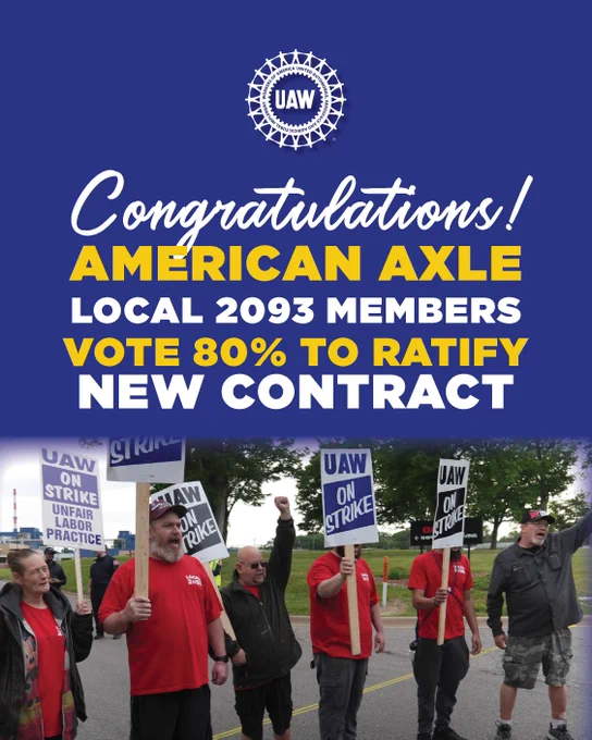 UAW members at American Axle celebrate after voting 80% to ratify a new contract, holding strike signs and raising fists.