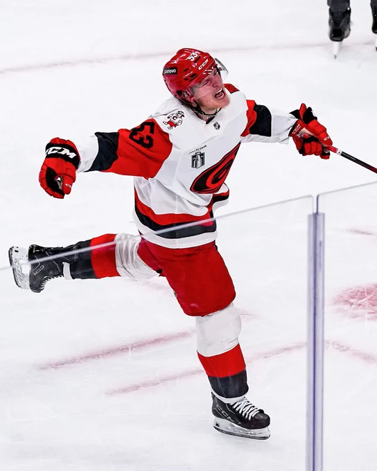 Jackson Blake celebrates a goal on ice in a Hurricanes uniform. 