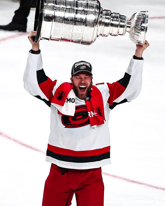 Taylor Hall lifts the Stanley Cup in a Hurricanes unfirom. 