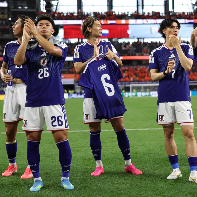 The Japan team hold up a Wataru Endo shirt to show their support after his withdrawal from the tournament due to injury 