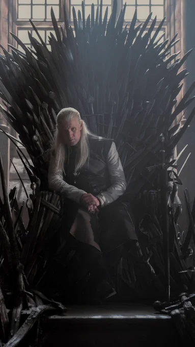 Prince Daemon Targaryen sitting on the Iron Throne 