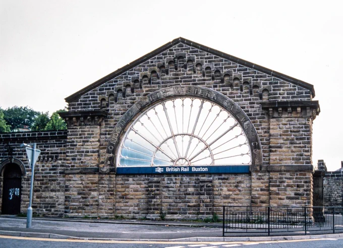The surviving end wall with fan window at Buxton LNWR station, with 'LONDON & NORTH WESTERN RAILWAY CO' carved into the semicircular stonework arch above the window