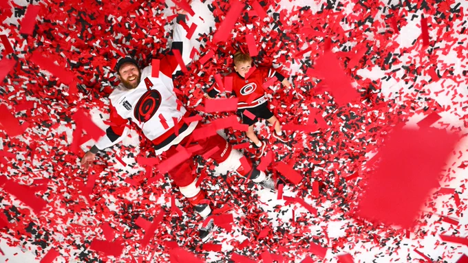 Photo of Jaccob Slavin and his kids in the confetti