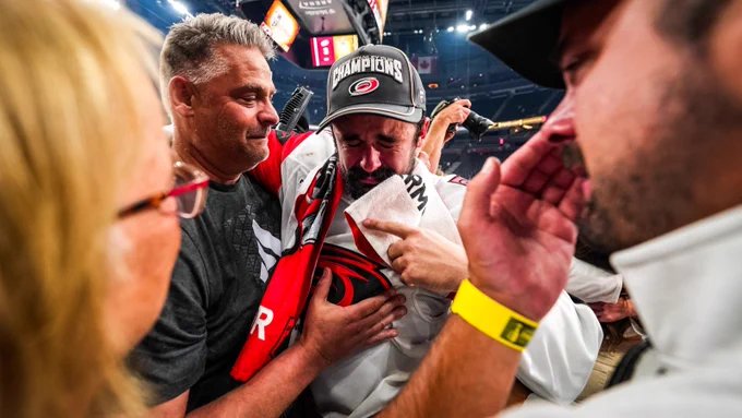 Photo of Seth Jarvis crying with his family after the Stanley Cup win
