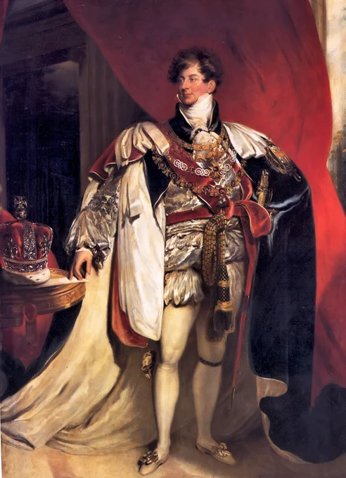 Portrait of an English king, standing in elaborate ceremonial robes. He wears a richly embroidered silver and white outfit with a crimson sash, gold regalia and the collar of a chivalric order. A long white fur-trimmed cloak drapes behind him, while his right hand rests on a ceremonial sword. To his left sits a royal crown on a table covered with red fabric. Large crimson curtains frame the scene, creating a grand backdrop that emphasises royal authority and status.