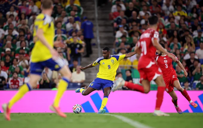 An image of Alexander Isak striking the ball as he scores against Tunisia in Group F of the World Cup