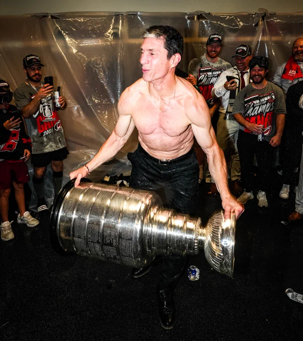 Photo of Rod Brind'Amour shirtless in the locker room with the Cup