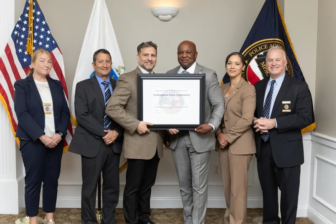 image of officer holding accreditation plaque