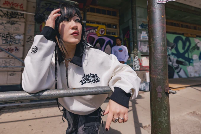 CB2026 Quarter Zip modeled in front of graffiti covered walkway.
