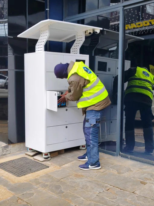 A rider swapping at a Powerhive battery swap station