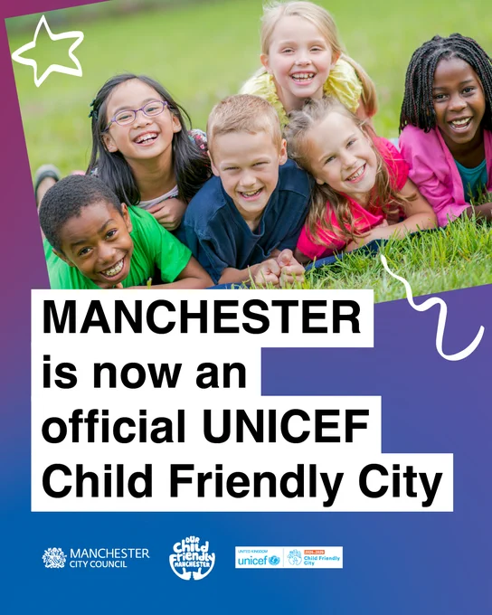 Children smiling on grass with text: Manchester is now an official UNICEF Child Friendly City.