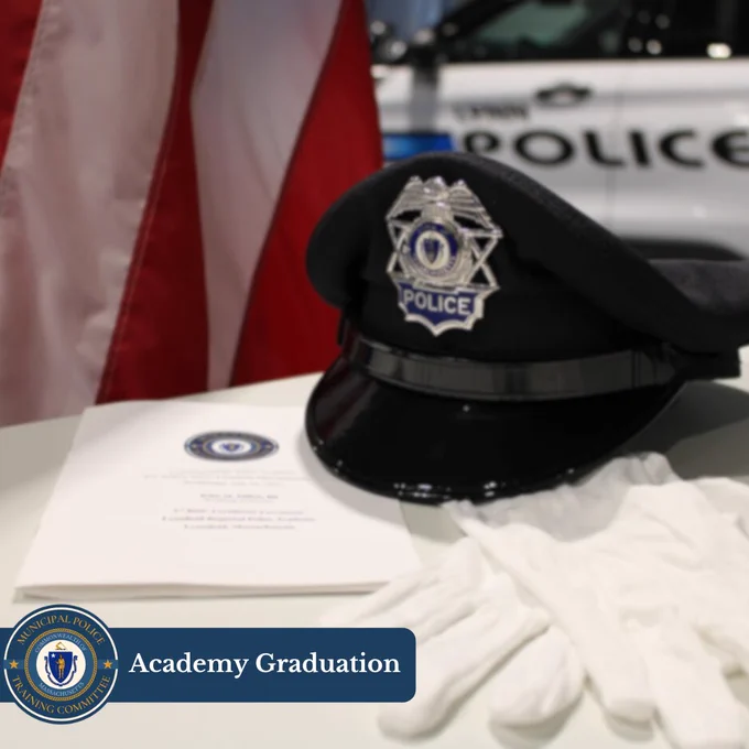 A police hat, ceremonial gloves, and a program with Academy Graduation in text.
