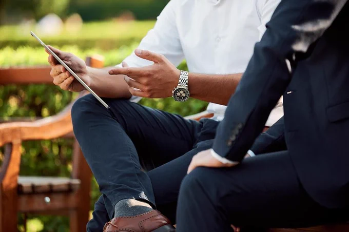 Men looking at a tablet