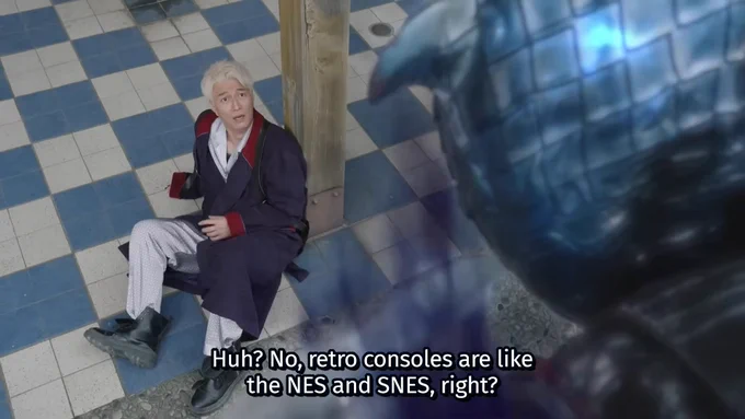 A shocked Sieg from Kamen Rider ZEZTZ sitting on the ground saying to the Punish Gore Nightmare, "Huh? No, retro consoles are like the NES and SNES, right?"