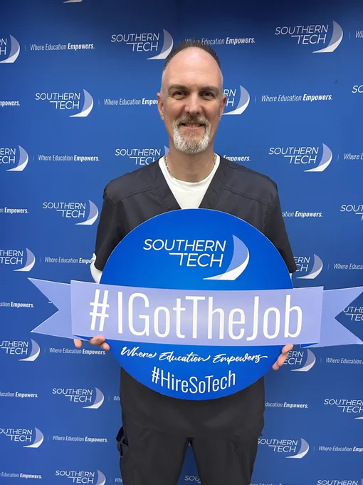 student holding an I got the job photo