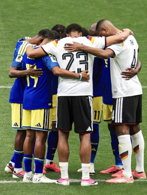 German and Curacao players pray together after the final whistle.