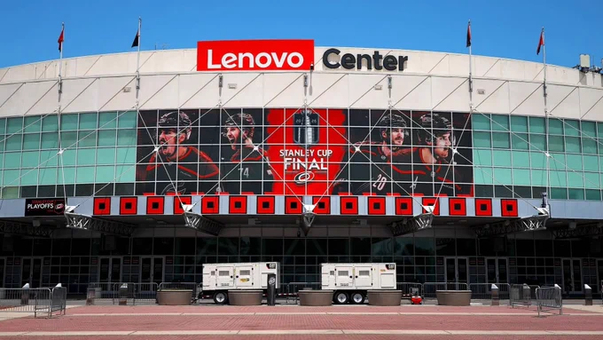 Shot of Lenovo Center with 16 win flags.