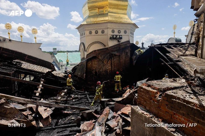 Firefighters work on the roof of the damaged Dormition Cathedral in the Orthodox complex of the Kyiv Pechersk Lavra in Kyiv on June 15, 2026, following a Russian missile and drone strike
