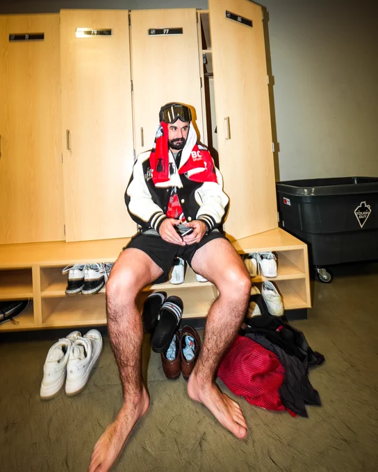 Photo of Seth Jarvis sitting in his locker after win the Stanley Cup