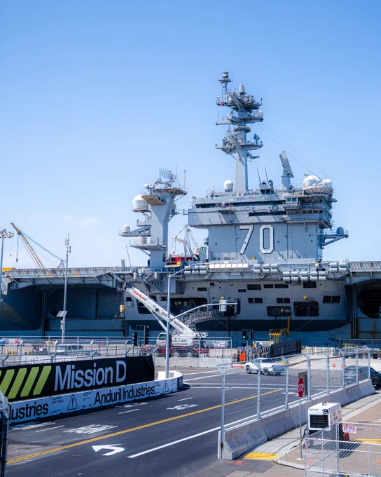 The course build in progress at Naval Base Coronado with an aircraft carrier in the background.