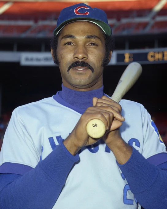 Posed portrait of Billy Williams wearing a road Chicago uniform with a bat leaning on his left shoulder. (Doug McWilliams/National Baseball Hall of Fame and Museum)