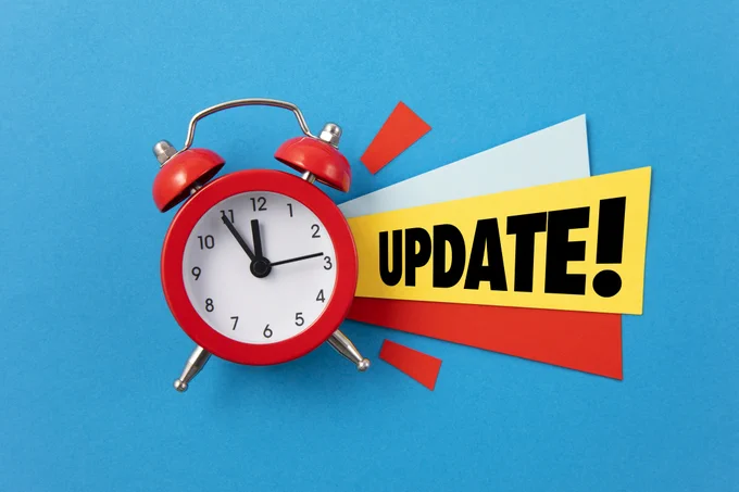 A red clock with the word update written next to it.