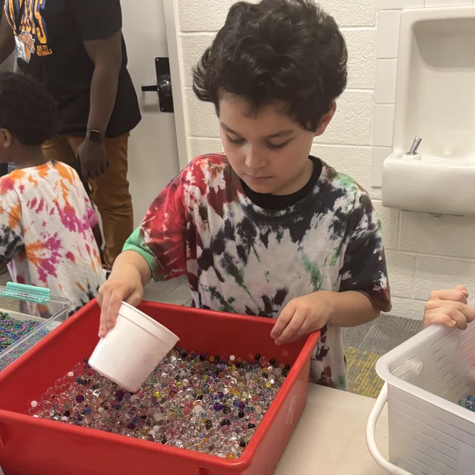 student works with garden box