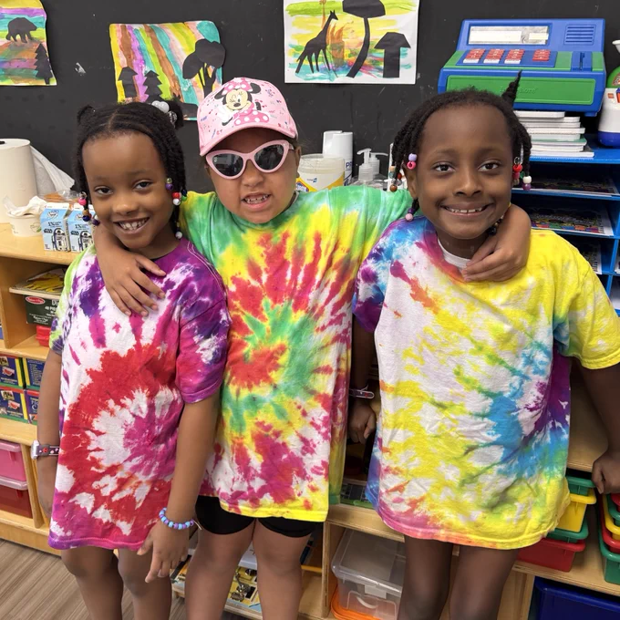three friends in tie-dyed tee shirts