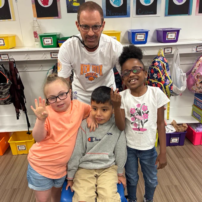 teacher and three students celebrating the Knicks' win