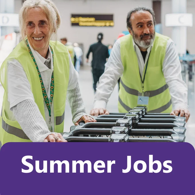 Two workers in high visibility vests move a line of trolleys through a bright indoor workplace or warehouse setting, with other people and work areas visible in the background. Large text overlay reads “Summer Jobs”.

Image credit: Disability Business Forum