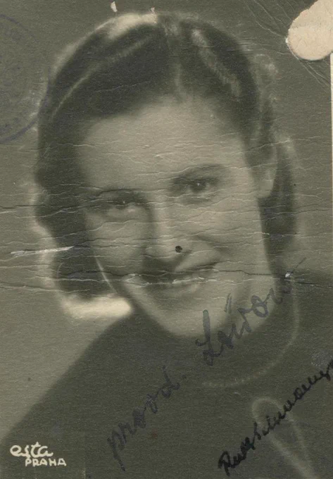 Black and white photograph of a smiling woman. The image features handwritten cursive text at the bottom.
