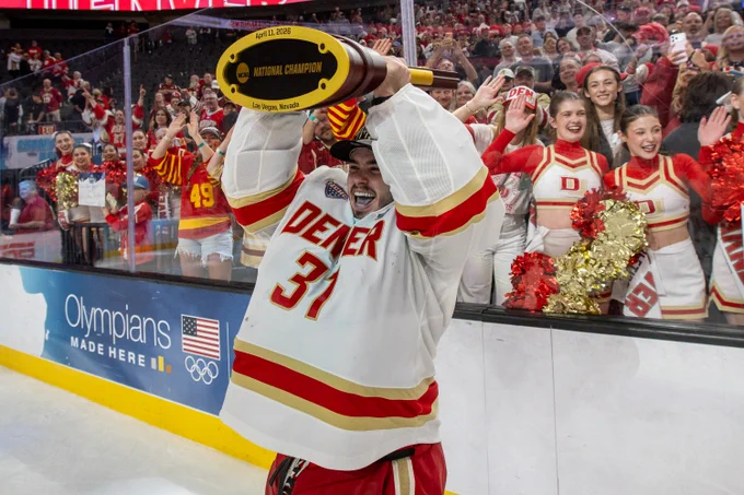 Denver goalie Johnny Hicks lifts the NCAA National Championship trophy in Las Vegas