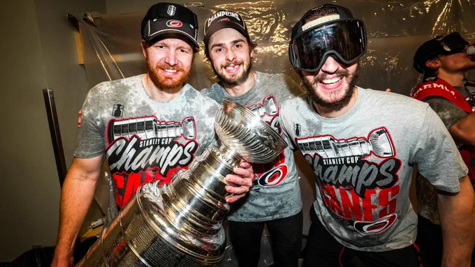 Photo of Frederik Andersen, Pyotr Kochetkov, and Brandon Bussi in the locker room with the Stanley Cup