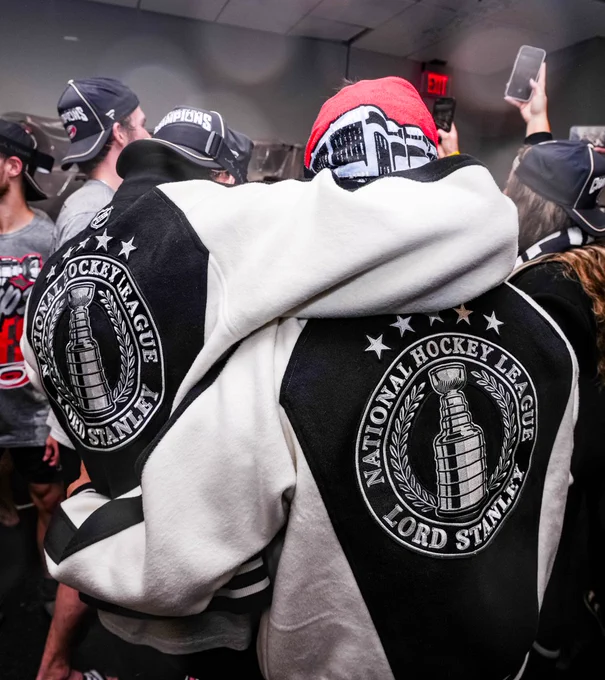 Photo of Seth Jarvis and Sebastian Aho posing for a photo with their Lord Stanley jackets