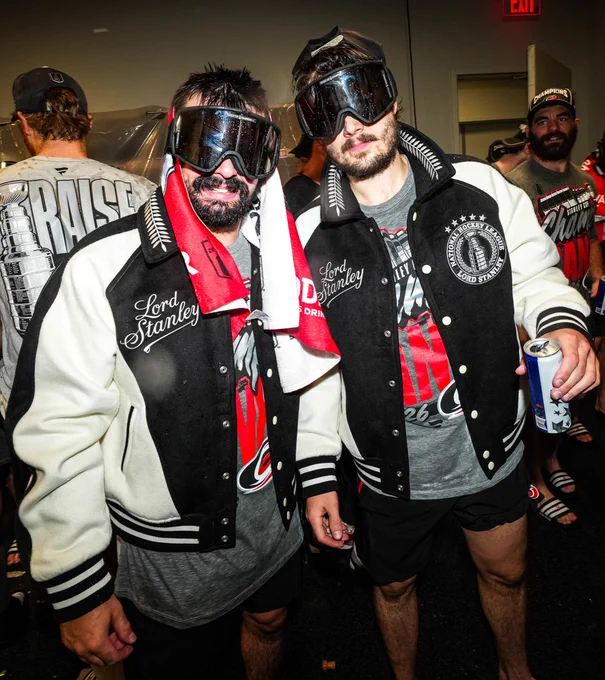 Photo of Seth Jarvis and Sebastian Aho posing for a photo with their Lord Stanley jackets