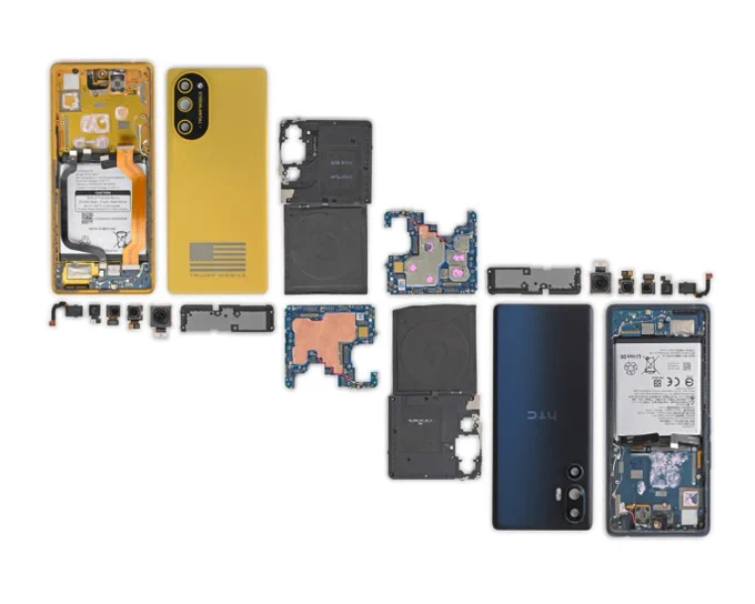 Side-by-side exploded views of two smartphones laid out with their internal components separated and arranged for comparison. On the left, a gold-colored Trump Mobile T1 phone is shown with its components removed. On the right, an HTC U24 Pro smartphone is displayed with a nearly identical arrangement of internal parts. The image highlights the strong similarities between the two devices' construction and component layouts.