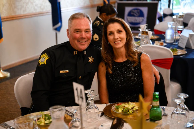 captain danny brown and his wife sitting at a table